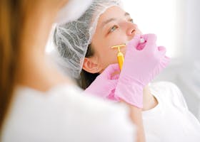 Close-up of a woman receiving a facial treatment at a beauty spa.